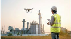 man-controlling-drone-at-industrial-facility