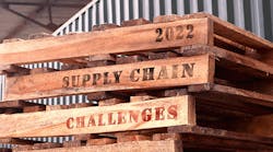 stack-of-three-shipping-pallets-with-2022-supply-chain-challenges-written-on-the-sides