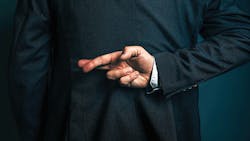 Image of business person from behind with their fingers crossed behind their back Image of business person from behind with their fingers crossed behind their back