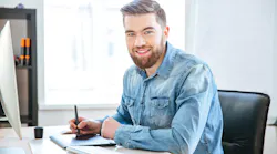 male engineer sitting at computer desk