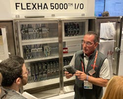 “The system can contain up to three banks and have 24 modules in a bank, giving 192 I/O points for simplex or 96 I/O points for duplex.” Rockwell Automation’s Armand Prezioso demonstrated the new FLEXHA 5000 configurable I/O platform at Automation Fair in Chicago. “The system can contain up to three banks and have 24 modules in a bank, giving 192 I/O points for simplex or 96 I/O points for duplex.” Rockwell Automation’s Armand Prezioso demonstrated the new FLEXHA 5000 configurable I/O platform at Automation Fair in Chicago.