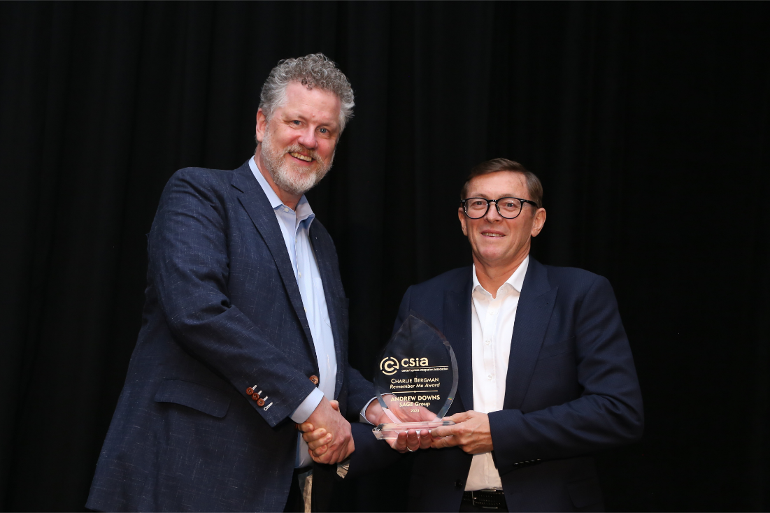 Wright Sullivan (l.), president of A&E Engineering Inc., and emcee of the 2023 CSIA awards dinner, presents the Charlie Bergman &ldquo;Remember Me&rdquo; award to Andrew Downs (r.), founder and executive director of Sage Group.