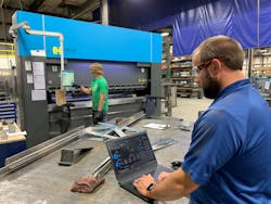 Dave Smit, senior systems analyst at Interstates (right), examines the network traffic dashboard and communication settings in Veracity OT Network Controller software at the system integrator’s prefabrication shop in Sioux Center, Iowa, while Jace Mulder, production technician (left), operates the Haco press break. OT Network Controller manages a software-defined network (SDN) switch from Dynics, and uses zero-trust and deny-by-default methods, which enables Interstates to improve network visibility and security for the machine and enhance operational efficiency. Source: Interstates Dave Smit, senior systems analyst at Interstates (right), examines the network traffic dashboard and communication settings in Veracity OT Network Controller software at the system integrator’s prefabrication shop in Sioux Center, Iowa, while Jace Mulder, production technician (left), operates the Haco press break. OT Network Controller manages a software-defined network (SDN) switch from Dynics, and uses zero-trust and deny-by-default methods, which enables Interstates to improve network visibility and security for the machine and enhance operational efficiency. Source: Interstates