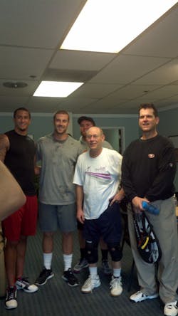 Weiss giving racquetball lessons to the San Francisco 49ers head coach and players