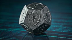 A 5-sided metal die with a shield and keyhole security symbol on each face of the die A 5-sided metal die with a shield and keyhole security symbol on each face of the die