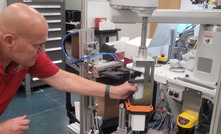 In system integrator Arthur G. Russell’s R&D and mock-up area in Bristol, Conn., senior R&D engineer Jerry Buchas adjusts a robot-actuated loader that brings a client’s product to the proper location in a case, so its end-of-arm tooling (EOT) with an attached actuator can push the product into place. AGR helps customers develop, test, and derisk their designs and requirements for new end-products and production systems. Its clients want to derisk because shorter product lifecycles and increasing demand for variety are compressing development and commissioning schedules.