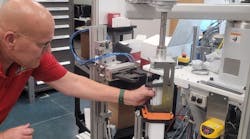 In system integrator Arthur G. Russell’s R&D and mock-up area in Bristol, Conn., senior R&D engineer Jerry Buchas adjusts a robot-actuated loader that brings a client’s product to the proper location in a case, so its end-of-arm tooling (EOT) with an attached actuator can push the product into place. AGR helps customers develop, test, and derisk their designs and requirements for new end-products and production systems. Its clients want to derisk because shorter product lifecycles and increasing demand for variety are compressing development and commissioning schedules. In system integrator Arthur G. Russell’s R&D and mock-up area in Bristol, Conn., senior R&D engineer Jerry Buchas adjusts a robot-actuated loader that brings a client’s product to the proper location in a case, so its end-of-arm tooling (EOT) with an attached actuator can push the product into place. AGR helps customers develop, test, and derisk their designs and requirements for new end-products and production systems. Its clients want to derisk because shorter product lifecycles and increasing demand for variety are compressing development and commissioning schedules.