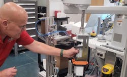 In system integrator Arthur G. Russell’s R&D and mock-up area in Bristol, Conn., senior R&D engineer Jerry Buchas adjusts a robot-actuated loader that brings a client’s product to the proper location in a case, so its end-of-arm tooling (EOT) with an attached actuator can push the product into place. AGR helps customers develop, test, and derisk their designs and requirements for new end-products and production systems. Its clients want to derisk because shorter product lifecycles and increasing demand for variety are compressing development and commissioning schedules. In system integrator Arthur G. Russell’s R&D and mock-up area in Bristol, Conn., senior R&D engineer Jerry Buchas adjusts a robot-actuated loader that brings a client’s product to the proper location in a case, so its end-of-arm tooling (EOT) with an attached actuator can push the product into place. AGR helps customers develop, test, and derisk their designs and requirements for new end-products and production systems. Its clients want to derisk because shorter product lifecycles and increasing demand for variety are compressing development and commissioning schedules.