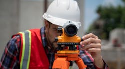 Civil or construction engineer using a survey camera Civil or construction engineer using a survey camera