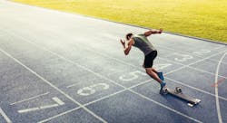 Rear view of an athlete starting his sprint on an all-weather running track Rear view of an athlete starting his sprint on an all-weather running track