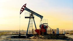 Crude oil pump jack at oilfield on sunset background Crude oil pump jack at oilfield on sunset background