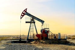 Crude oil pump jack at oilfield on sunset background Crude oil pump jack at oilfield on sunset background