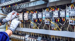 Electricity and electrical maintenance service, Engineer hand holding AC voltmeter checking electric current voltage at circuit breaker terminal and cable wiring main power distribution board. Electricity and electrical maintenance service, Engineer hand holding AC voltmeter checking electric current voltage at circuit breaker terminal and cable wiring main power distribution board.