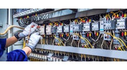 Electricity and electrical maintenance service, Engineer hand holding AC voltmeter checking electric current voltage at circuit breaker terminal and cable wiring main power distribution board. Electricity and electrical maintenance service, Engineer hand holding AC voltmeter checking electric current voltage at circuit breaker terminal and cable wiring main power distribution board.