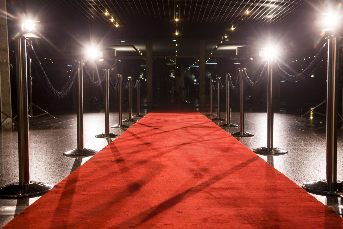 Long red carpet between rope barriers on entrance.
