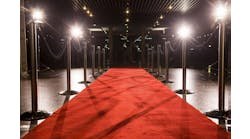 Long red carpet between rope barriers on entrance. Long red carpet between rope barriers on entrance.