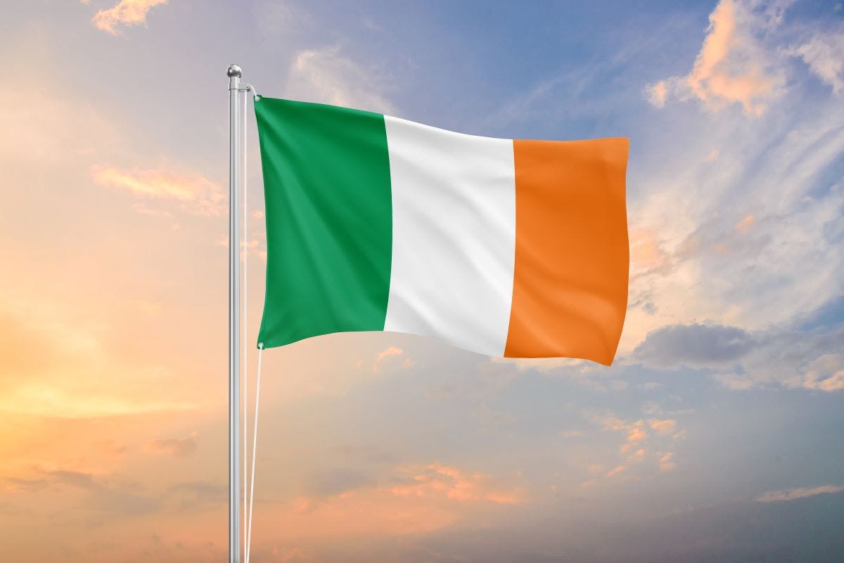 Ireland flag waving on sundown sky