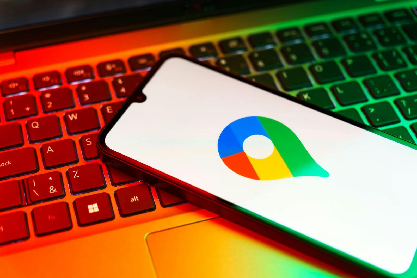 Smartphone on surface showing Google Maps logo