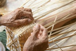 Senior man hands manually weaving bamboo. Senior man hands manually weaving bamboo.