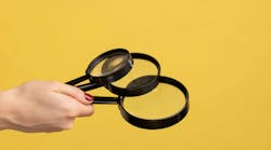 Profile side view closeup of woman hand holding several magnify glasses, loupe. Indoor studio shot isolated on yellow background. Profile side view closeup of woman hand holding several magnify glasses, loupe. Indoor studio shot isolated on yellow background.