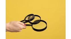 Profile side view closeup of woman hand holding several magnify glasses, loupe. Indoor studio shot isolated on yellow background. Profile side view closeup of woman hand holding several magnify glasses, loupe. Indoor studio shot isolated on yellow background.
