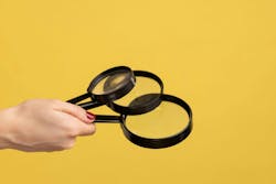 Profile side view closeup of woman hand holding several magnify glasses, loupe. Indoor studio shot isolated on yellow background. Profile side view closeup of woman hand holding several magnify glasses, loupe. Indoor studio shot isolated on yellow background.