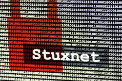The name of the computer virus Stuxnet in front of a binary background The name of the computer virus Stuxnet in front of a binary background