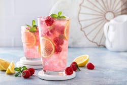 Spring or summer refreshing cold cocktail or mocktail with berries and lemon, raspberry lemonade Spring or summer refreshing cold cocktail or mocktail with berries and lemon, raspberry lemonade