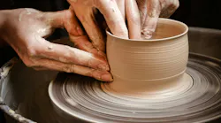 Master class on modeling of clay on a potter's wheel In the pottery workshop