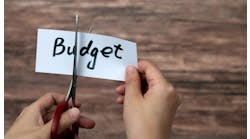 Scissors cutting word budget on paper Scissors cutting word budget on paper