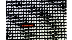 The name of the computer virus Stuxnet in front of a binary background The name of the computer virus Stuxnet in front of a binary background