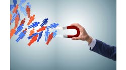 Businessman in recruitment concept with horseshoe magnet Businessman in recruitment concept with horseshoe magnet