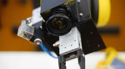 A robot in a factory equipped with a machine vision camera. A robot in a factory equipped with a machine vision camera.