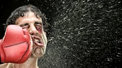 boxer man takes a punch in the face isolated on black. boxer man takes a punch in the face isolated on black.