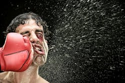 boxer man takes a punch in the face isolated on black. boxer man takes a punch in the face isolated on black.