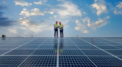 Engineers walking on roof inspect and check solar cell panel by holding equipment box and radio communication Engineers walking on roof inspect and check solar cell panel by holding equipment box and radio communication
