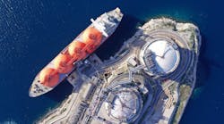 Aerial drone top down photo of LNG (Liquified Natural Gas) tanker anchored in small gas terminal island with tanks for storage to store and regasify LNG Aerial drone top down photo of LNG (Liquified Natural Gas) tanker anchored in small gas terminal island with tanks for storage to store and regasify LNG