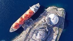 Aerial drone top down photo of LNG (Liquified Natural Gas) tanker anchored in small gas terminal island with tanks for storage to store and regasify LNG Aerial drone top down photo of LNG (Liquified Natural Gas) tanker anchored in small gas terminal island with tanks for storage to store and regasify LNG