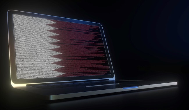 Flag of Qatar made with computer code on the laptop screen.
