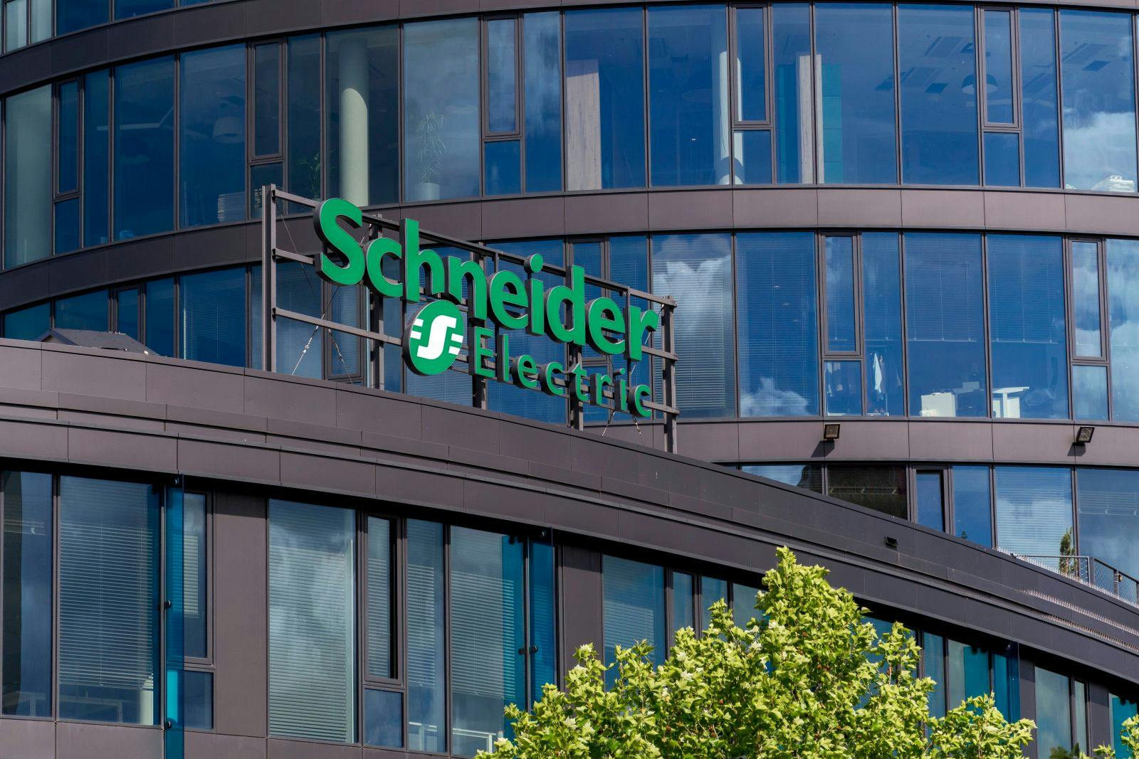 Schneider Electric automation and energy management company logo on headquarters in Prague