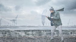 Pedestrian with an umbrella is facing strong wind and rain on a dockside Pedestrian with an umbrella is facing strong wind and rain on a dockside