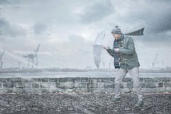 Pedestrian with an umbrella is facing strong wind and rain on a dockside Pedestrian with an umbrella is facing strong wind and rain on a dockside