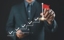 Business success and goal achievement steps. Businessman drawing checkmarks on virtual staircase steps toward achieving goals, ending with red flag as success marker. Planning, progress, goal setting, Business success and goal achievement steps. Businessman drawing checkmarks on virtual staircase steps toward achieving goals, ending with red flag as success marker. Planning, progress, goal setting,