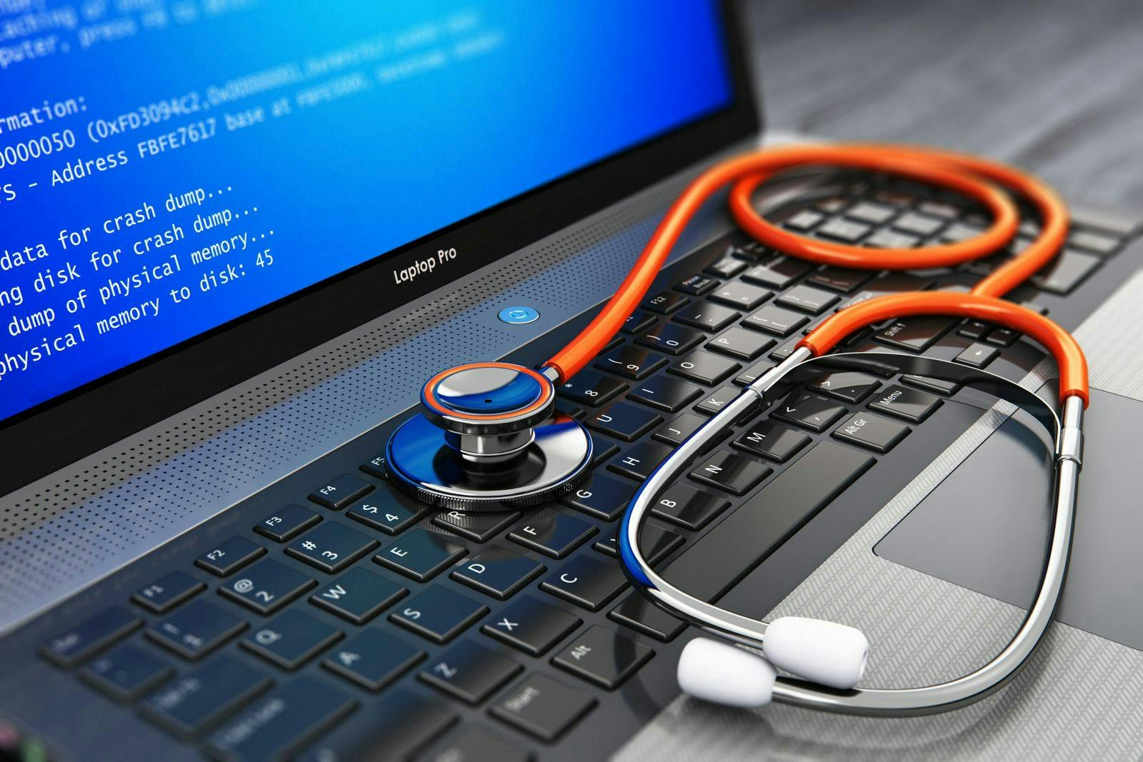 Computer bug, virus and service, repair and maintenance technology concept: 3D render of business laptop or notebook PC with error message on blue screen BSOD and red medical stethoscope on keyboard