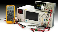 Various electronic testing devices are arranged on a workbench, showcasing multimeter readings and setup for analysis and measurement tasks. Various electronic testing devices are arranged on a workbench, showcasing multimeter readings and setup for analysis and measurement tasks.