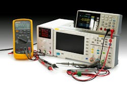 Various electronic testing devices are arranged on a workbench, showcasing multimeter readings and setup for analysis and measurement tasks. Various electronic testing devices are arranged on a workbench, showcasing multimeter readings and setup for analysis and measurement tasks.