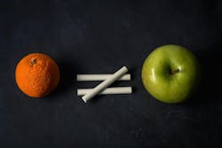 Orange does not equal apple with chalk on top of chalkboard suggesting inequality in different fruit Orange does not equal apple with chalk on top of chalkboard suggesting inequality in different fruit