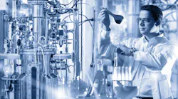 Black and white image of a scientist looking at a test tube in a laboratory Black and white image of a scientist looking at a test tube in a laboratory