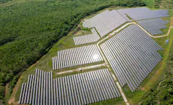 Drone view of a solar power station next to a forest during summer. Drone view of a solar power station next to a forest during summer.