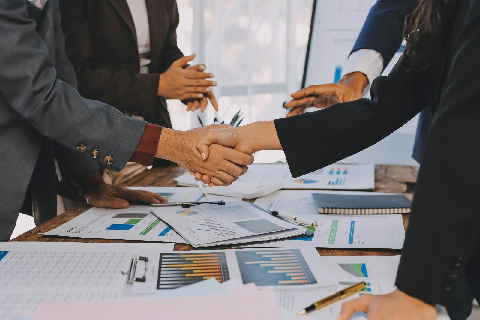 Business handshake for teamwork of business merger and acquisition,successful negotiate,hand shake,two businessman shake hand with partner to celebration partnership and business deal concept